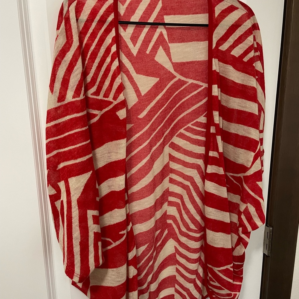 Very cute sweater shrug. Light weight knit material. Cream and red zebra print